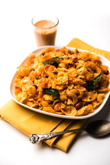Cornflake Chivda or Corn Chiwda loaded with peanuts and Cashew. Served in a bowl. selective focus