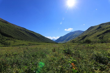 Landscape views of the Caucasus Mountains, river and villages. Peak and river Enguri. Georgia. Summer. 2019