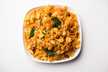Cornflake Chivda or Corn Chiwda loaded with peanuts and Cashew. Served in a bowl. selective focus