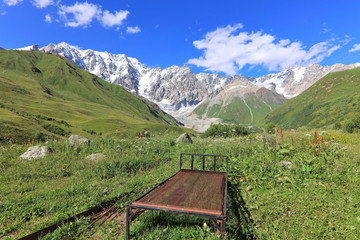 Landscape views of the Caucasus Mountains, river and villages. Peak and river Enguri. Georgia. Summer. 2019