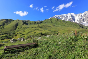 Landscape views of the Caucasus Mountains, river and villages. Peak and river Enguri. Georgia. Summer. 2019