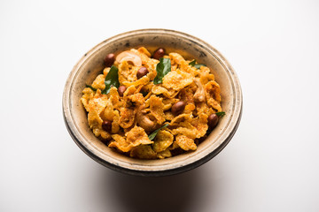Cornflake Chivda or Corn Chiwda loaded with peanuts and Cashew. Served in a bowl. selective focus