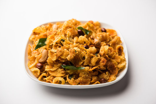 Cornflake Chivda or Corn Chiwda loaded with peanuts and Cashew. Served in a bowl. selective focus