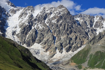 Landscape views of the Caucasus Mountains, river and villages. Peak and river Enguri. Georgia. Summer. 2019