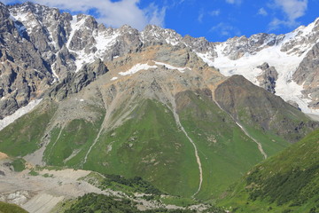 Landscape views of the Caucasus Mountains, river and villages. Peak and river Enguri. Georgia. Summer. 2019