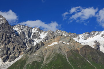 Landscape views of the Caucasus Mountains, river and villages. Peak and river Enguri. Georgia. Summer. 2019