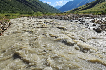 Landscape views of the Caucasus Mountains, river and villages. Peak and river Enguri. Georgia. Summer. 2019
