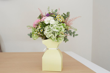 Cardboard box with bouquet of flowers
