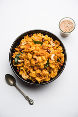 Cornflake Chivda or Corn Chiwda loaded with peanuts and Cashew. Served in a bowl. selective focus