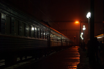 Naklejka na ściany i meble Train on the platform of the railway station at night
