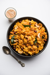 Cornflake Chivda or Corn Chiwda loaded with peanuts and Cashew. Served in a bowl. selective focus