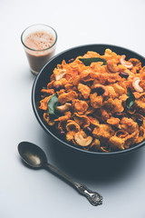 Cornflake Chivda or Corn Chiwda loaded with peanuts and Cashew. Served in a bowl. selective focus