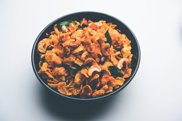 Cornflake Chivda or Corn Chiwda loaded with peanuts and Cashew. Served in a bowl. selective focus