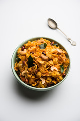 Cornflake Chivda or Corn Chiwda loaded with peanuts and Cashew. Served in a bowl. selective focus