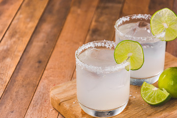 close-up of ice homemade lemonade with lime and salt on wooden cutting board