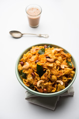 Cornflake Chivda or Corn Chiwda loaded with peanuts and Cashew. Served in a bowl. selective focus
