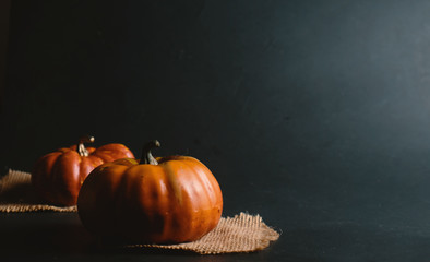 Orange Halloween pumpkin with black background, fall or autumn graphic element. 