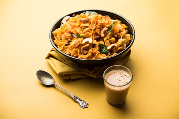 Cornflake Chivda or Corn Chiwda loaded with peanuts and Cashew. Served in a bowl. selective focus