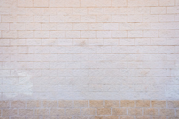 White brick wall with a rough texture.