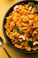 Cornflake Chivda or Corn Chiwda loaded with peanuts and Cashew. Served in a bowl. selective focus