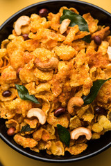Cornflake Chivda or Corn Chiwda loaded with peanuts and Cashew. Served in a bowl. selective focus