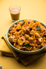 Cornflake Chivda or Corn Chiwda loaded with peanuts and Cashew. Served in a bowl. selective focus