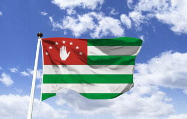 Mockup of Abkhazia flag fluttering under blue sky. Caucasus region, autonomous republic in northern Georgia. Independence internationally recognized by Russia, Nicaragua, Venezuela and Nauru. Sukhumi