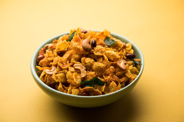 Cornflake Chivda or Corn Chiwda loaded with peanuts and Cashew. Served in a bowl. selective focus