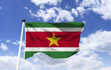 Suriname flag mockup fluttering under blue sky. Small South American country. On the Atlantic coast lies the capital Paramaribo, which houses the high Cathedral of St. Peter and St. Paul