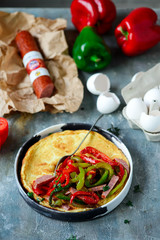 Omelet with pepper and salami.style rustic