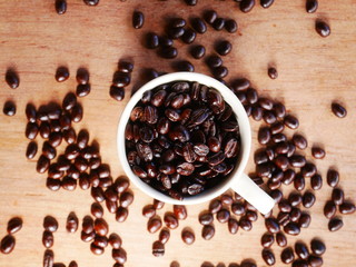 coffee beans and cinnamon sticks on white background