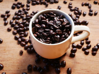 cup of coffee and beans on wooden background, organic aroma coffee