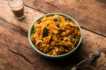 Cornflake Chivda or Corn Chiwda loaded with peanuts and Cashew. Served in a bowl. selective focus