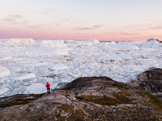 Travel in arctic landscape nature with icebergs - Greenland tourist man explorer - tourist person...