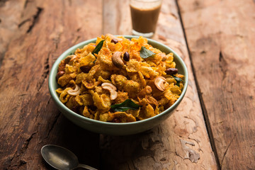 Cornflake Chivda or Corn Chiwda loaded with peanuts and Cashew. Served in a bowl. selective focus