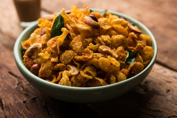 Cornflake Chivda or Corn Chiwda loaded with peanuts and Cashew. Served in a bowl. selective focus