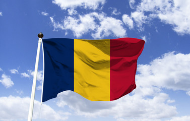 Chad flag mockup fluttering under blue sky. Pan African Colors, a landlocked country in northern central Africa. Capital and most populous city: Djamena. One of the poorest countries.