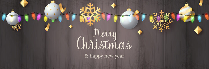 Merry Christmas banner with balls on grey wooden ground. Lettering can be used for invitations, post cards, announcements