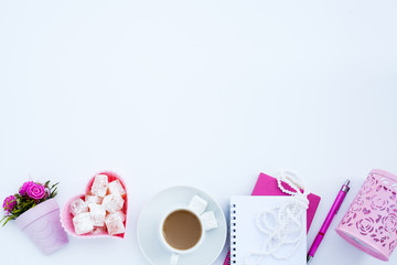 Flat lay girly, pale pink items for planning, notepads, pens, office work or working at home on her laptop, on the pale white background, with place for labels. Concept Desk.