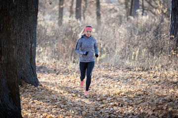 Fototapeta premium Young fitness woman running in the park