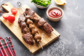 Beef Shish kebab and mushrooms, cherry tomato and ketchup Grilled meat skewers. BBQ lanch. Copyspace