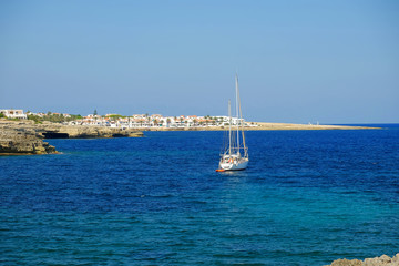 View on a white boat and the beach Alcaufar on Menorca.