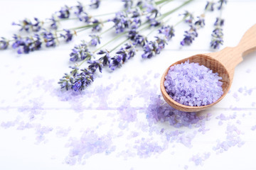 Fototapeta na wymiar Lavender flowers and spa salt on white wooden table
