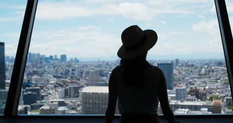 Woman enjoy the view of Tokyo city at observation deck
