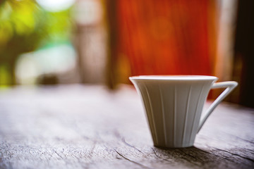 cappuccino coffee cup with beautiful latte art on old dark wooden table in coffee shop.