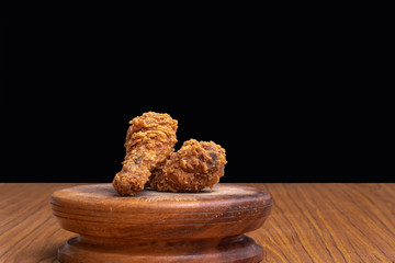 Delicious crispy fried chicken on black background