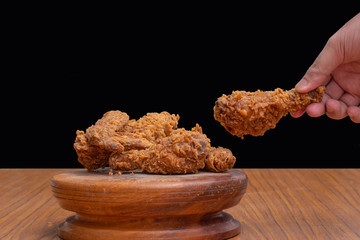 Delicious crispy fried chicken on black background