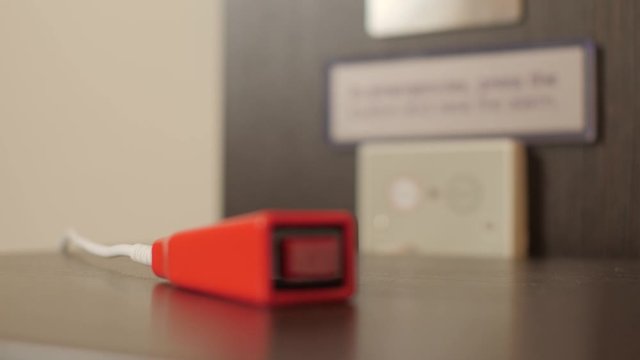 Bedside Panic alarm button for handicapped persons rack focus with sign call for assistance