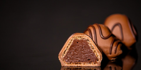 chocolate candies stuffed (sweets on a dark background) menu concept. food background. copy space. Top view