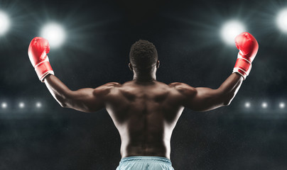 African american boxer raising his arms in winner gesture